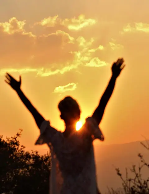 A person with their arms raised in the air.