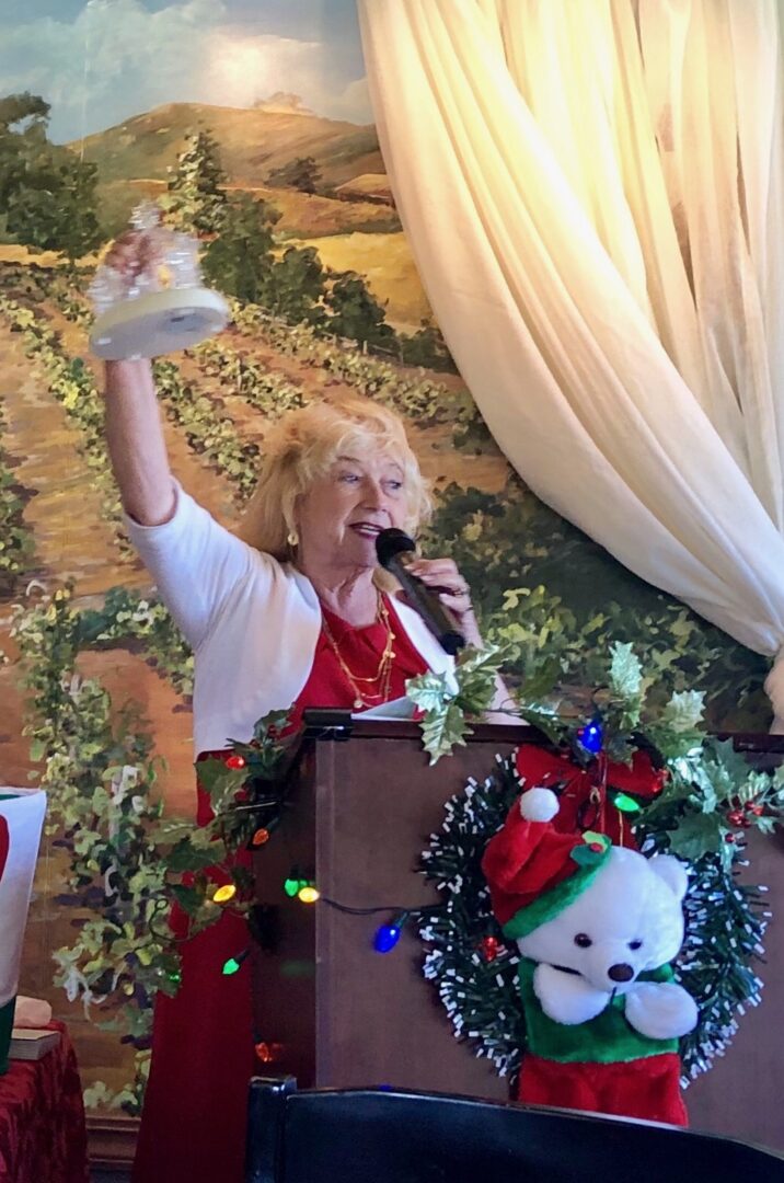 A woman is speaking at the christmas party.